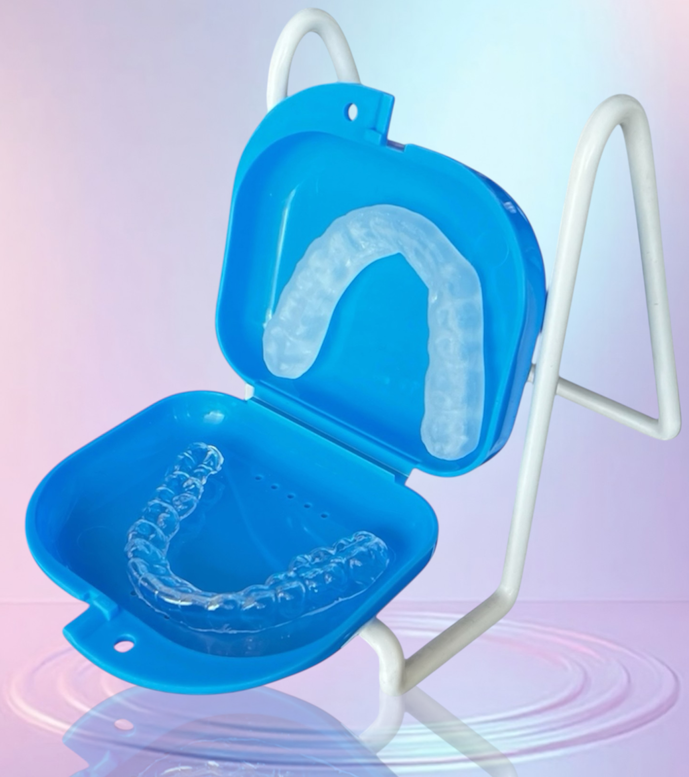 Custom dental night guard placed inside an open blue storage case on a soft gradient background.